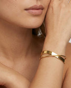 Model wearing 18K gold plated sculptural twist cuff bracelet — HYFN
